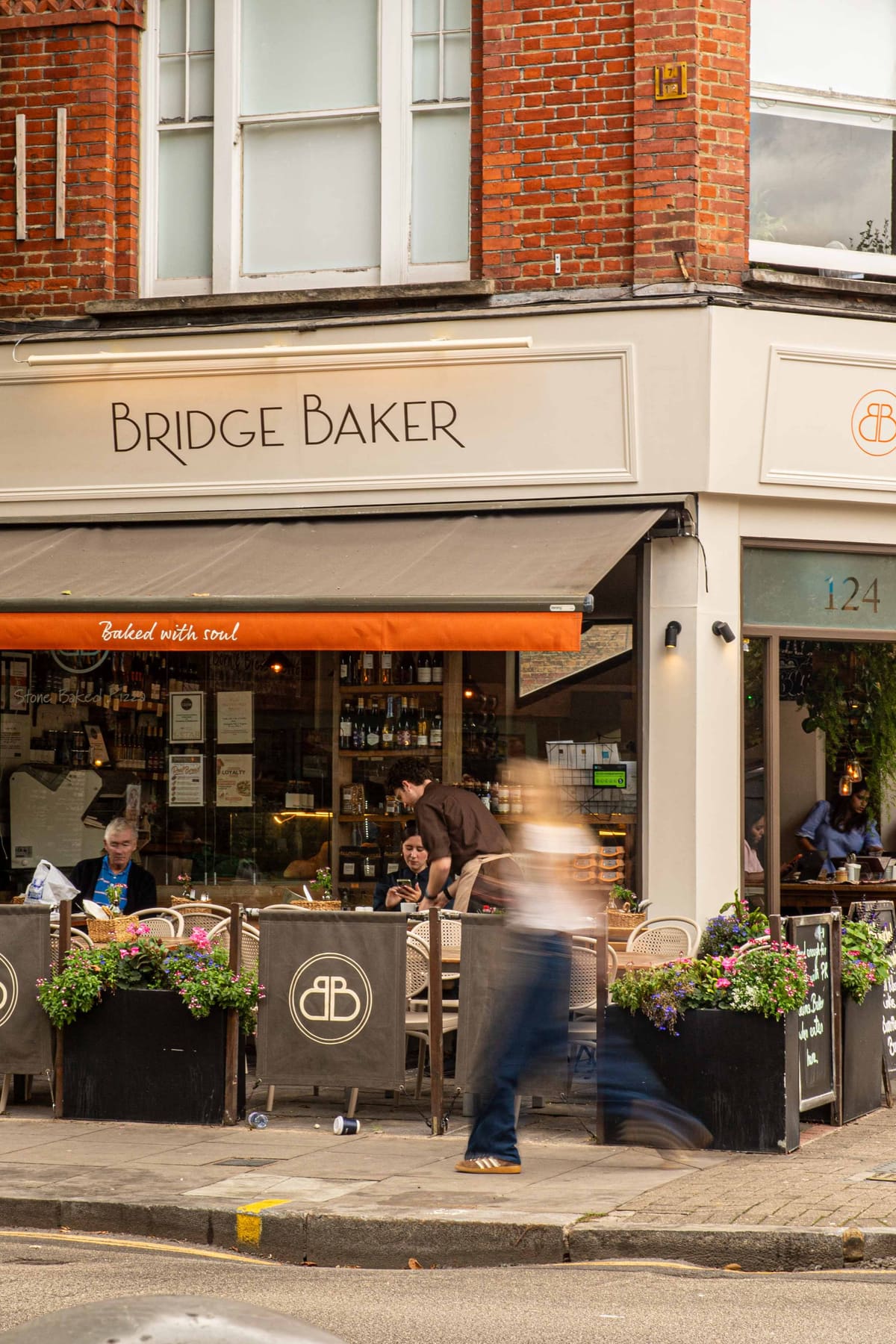 Customers at the tables outside the Bridge Baker corner shopfront