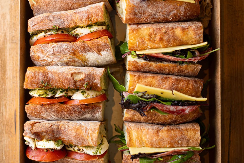 A catering box of filled baguettes from above